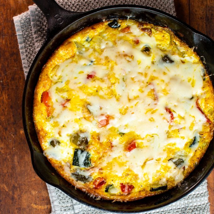 Cheesy frittata in a cast iron skillet.