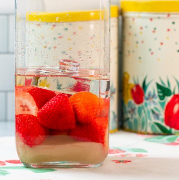 Jar with strawberries, sugar and rum.