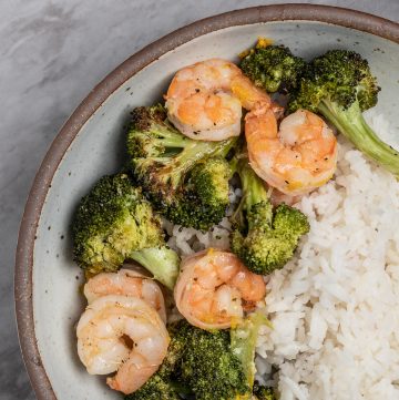 Bowl of roasted shrimp and broccoli.