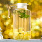Pitcher filled with water, pineapple, and mint.