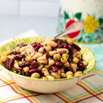 Green bowl filled with a 3 bean salad.