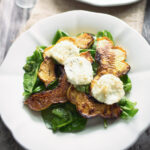 Acorn squash salad on a white plate.