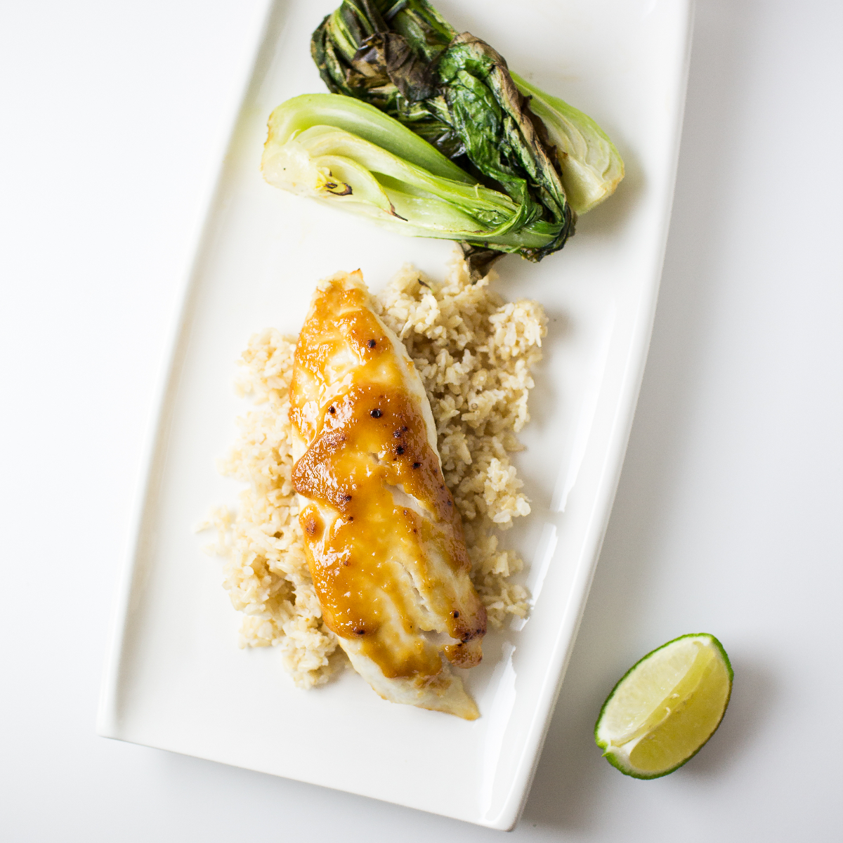 Miso glazed fish on a white platter.