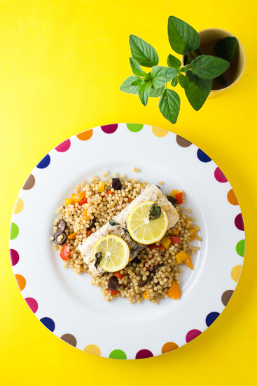 Mahi Mahi restiing atop mediterranean couscous.