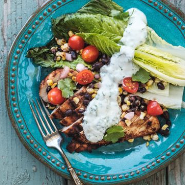 Plate of grilled chicken with corn and black bean salsa