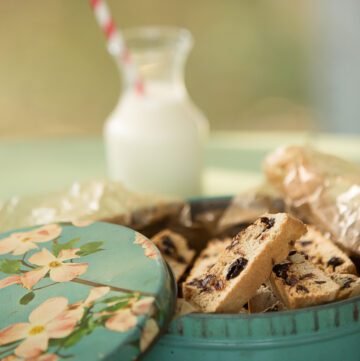 Close up of chocolate cherry biscotti in a vintage tin.