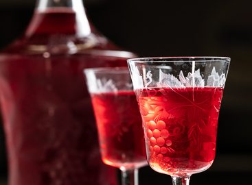 Decanter and two glasses of red cranberry liqueur.