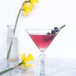 Blueberry elderflower martini in a martini glass.