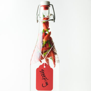 Bottle filled with vinegar and peppers.