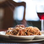 Steamy plate of pasta bolognese.
