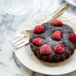 Close up of dark chocolate raspberry brownie tart.