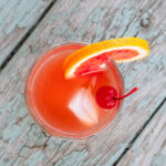 Top down view of a blood orange whiskey sour.
