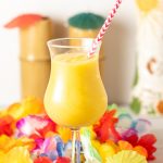 Frozen mango daiquiri in a hurricane glass.