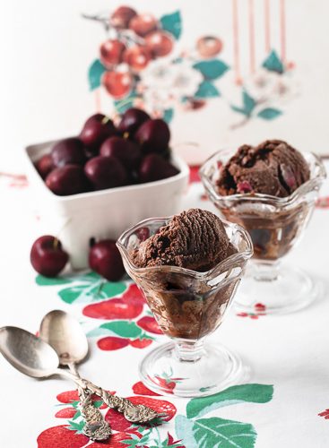 Two sundae glasses with cherry chocolate sorbet.