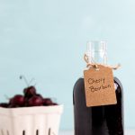 Bottle with deep red liquid labeled Cherry Bourbon.