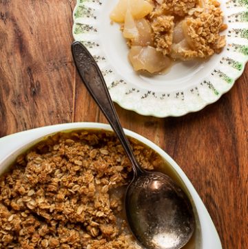 Pear crisp scooped out on a plate.