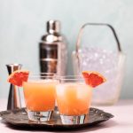 Two glasses of a pretty orange greyhound cocktail.