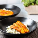 Bowl of glazed salmon over rice
