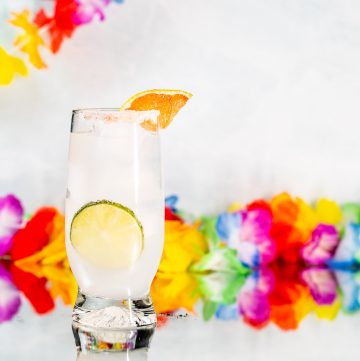 Cocktail garnished with a lime wheel and grapefruit wedge.