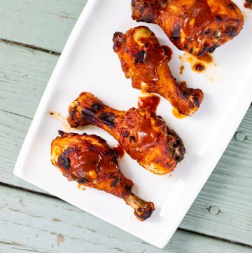 Plate with barbecued chicken legs.