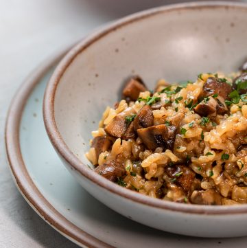 Mushroom risotto in a stoneware bowl.