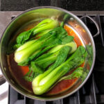 Skillet with baby bok choy.