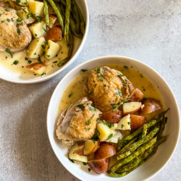 Two bowls of chicken and potatoes.
