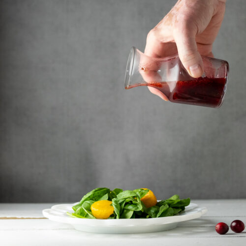 Cranberry salad dressing drizzled on a salad.