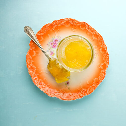 Mango marmalade on an orange plate.