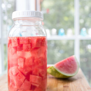Watermelon cubed in a large jar of tequila.