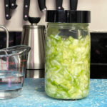 Jar of cabbage with a fermenting lid for making sauerkraut.